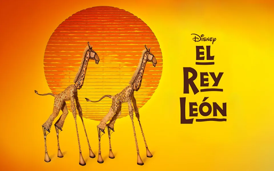 El Rey León Madrid artwork with giraffes against a golden sun
